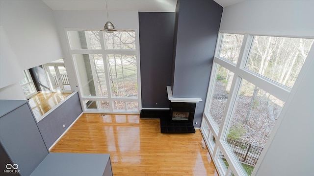 living room featuring hardwood / wood-style flooring, a tile fireplace, and a wealth of natural light