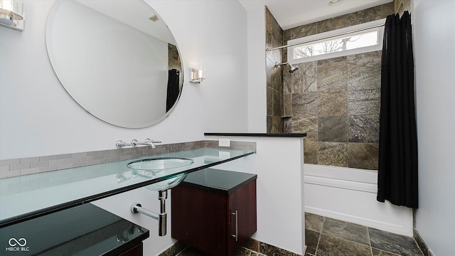 bathroom featuring vanity and tiled shower / bath