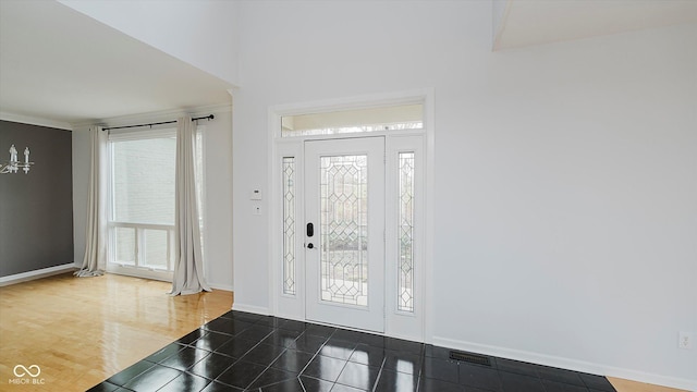 entrance foyer with crown molding and hardwood / wood-style flooring