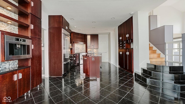 kitchen with tasteful backsplash, a center island, and appliances with stainless steel finishes