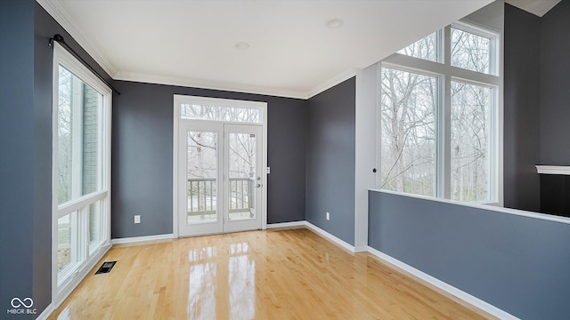 doorway with hardwood / wood-style flooring and ornamental molding