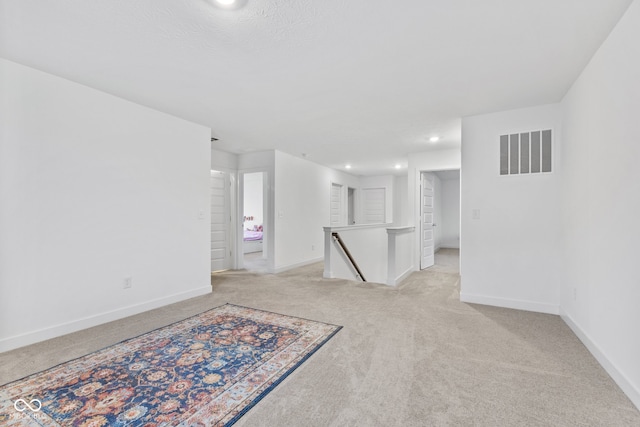 unfurnished room with light colored carpet