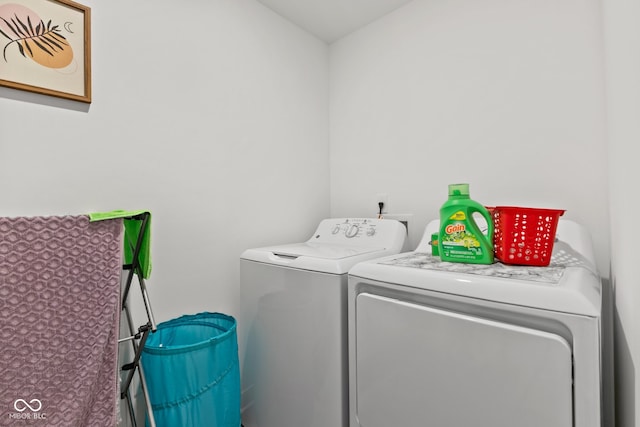 clothes washing area with washing machine and clothes dryer