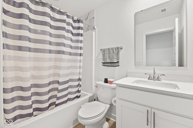 full bathroom with shower / bath combo, vanity, and toilet