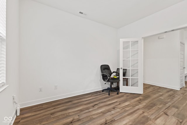 unfurnished office with french doors, lofted ceiling, and hardwood / wood-style flooring