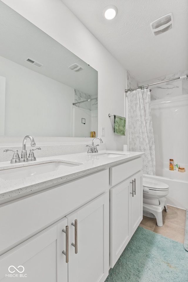 full bathroom with tile patterned floors, a textured ceiling, vanity, shower / bathtub combination with curtain, and toilet