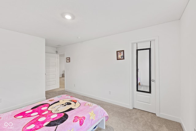 bedroom featuring light carpet