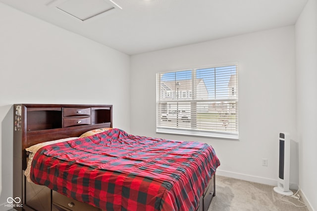 bedroom with multiple windows and light colored carpet