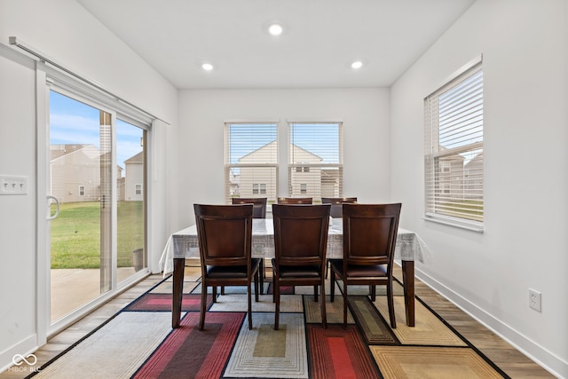 dining area with dark hardwood / wood-style flooring and a wealth of natural light