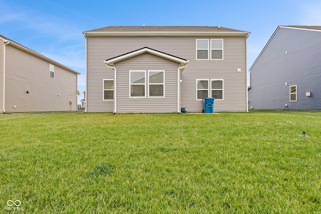 back of house featuring a yard