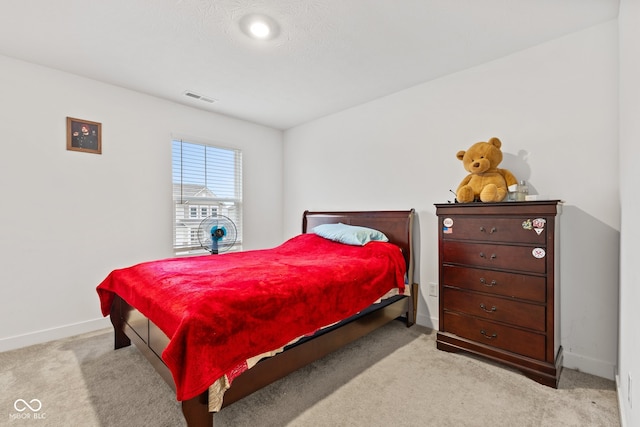 bedroom featuring light colored carpet