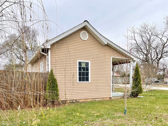 view of side of home featuring a lawn