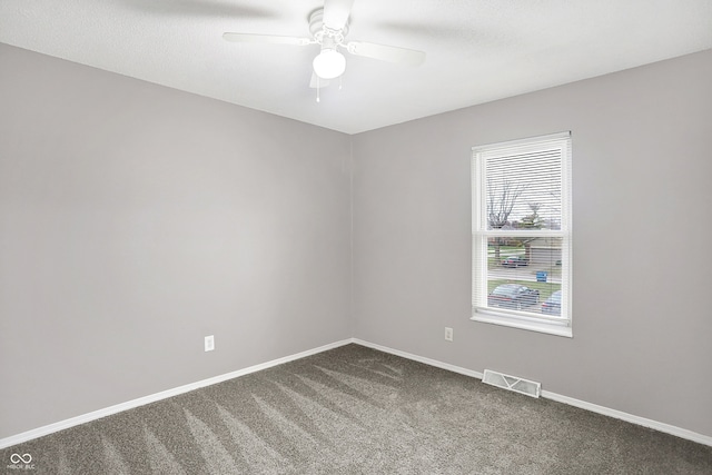 carpeted empty room featuring ceiling fan