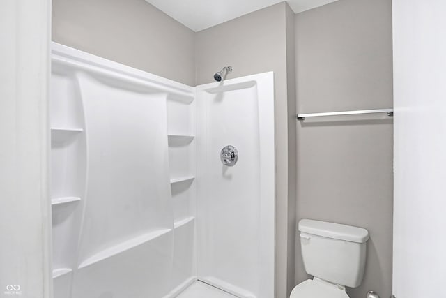 bathroom with toilet and walk in shower