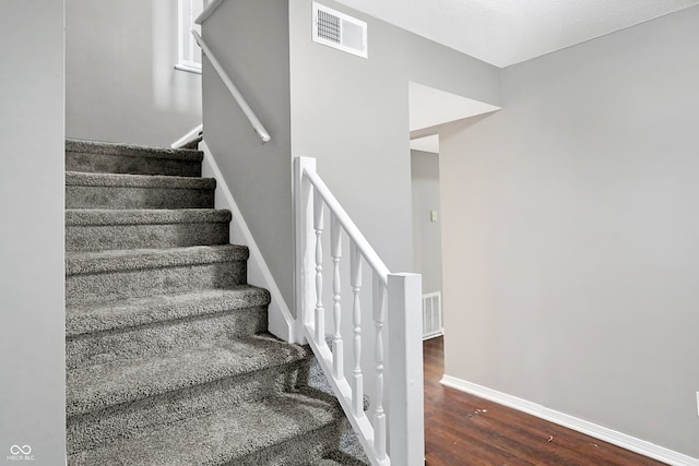 stairway with wood-type flooring