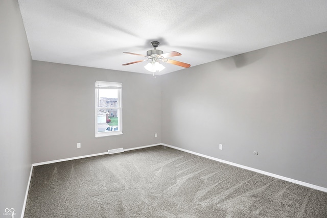 spare room featuring carpet flooring, a textured ceiling, and ceiling fan