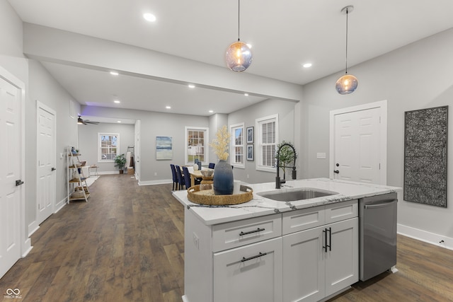 kitchen featuring dishwasher, sink, dark wood-type flooring, an island with sink, and pendant lighting