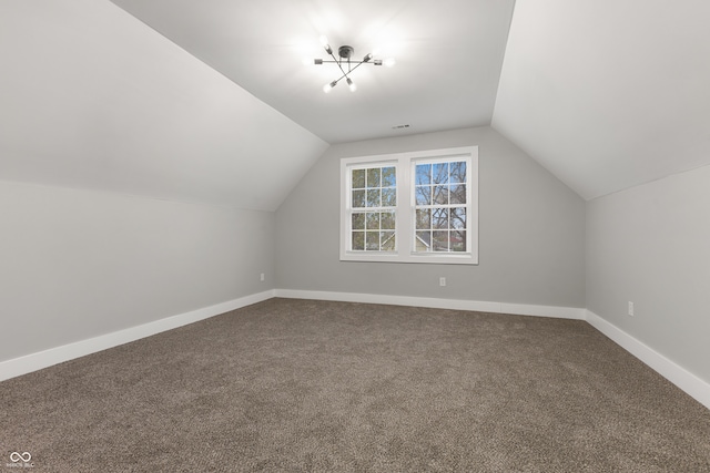 bonus room featuring carpet flooring and vaulted ceiling