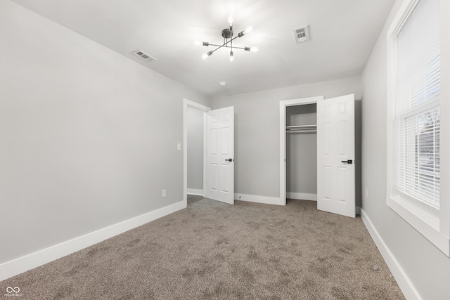 unfurnished bedroom featuring carpet, a closet, and multiple windows