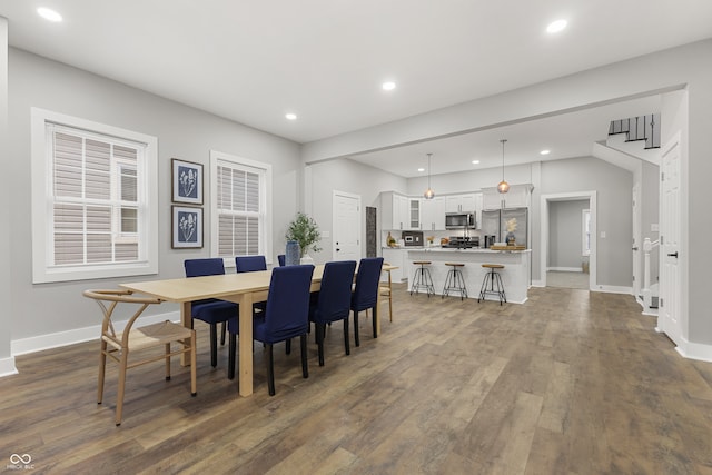 dining space with dark hardwood / wood-style flooring