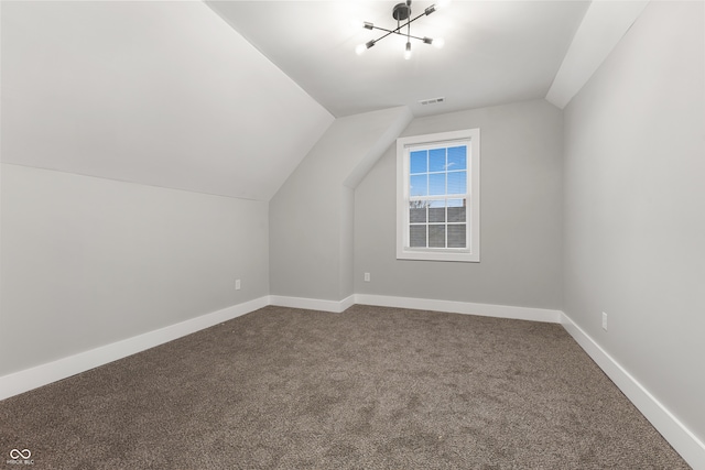 additional living space featuring carpet and vaulted ceiling