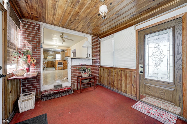 80 S Mickley Ave, Indianapolis, IN 46241 - entryway featuring wood ceiling, carpet flooring, wood walls, ceiling fan, and a fireplace