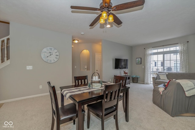 carpeted dining room featuring ceiling fan