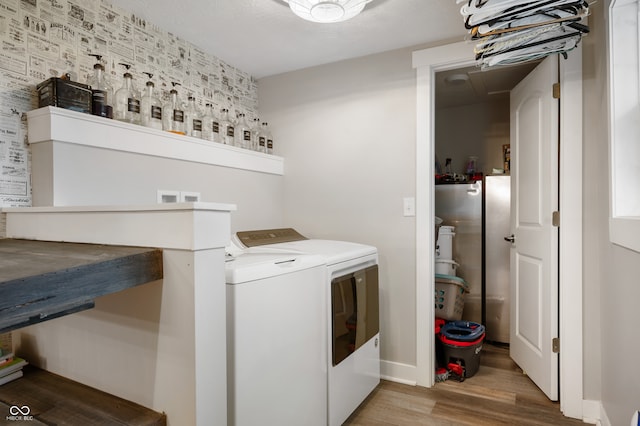 clothes washing area featuring washer and dryer and wood-type flooring