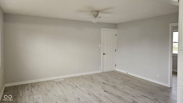 spare room featuring ceiling fan, light hardwood / wood-style flooring, and a textured ceiling