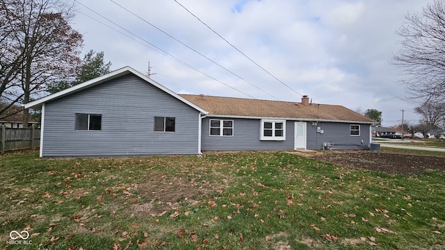 rear view of house with a yard