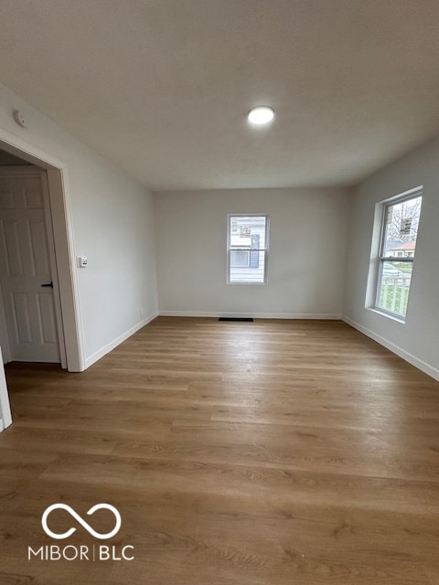 unfurnished room with light hardwood / wood-style flooring