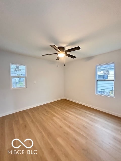 empty room featuring ceiling fan and light wood-type flooring