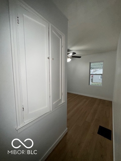 corridor featuring dark hardwood / wood-style flooring