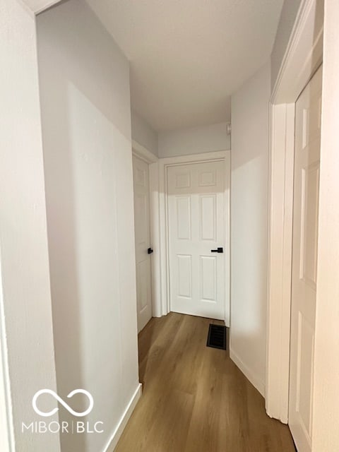 hallway featuring dark hardwood / wood-style flooring