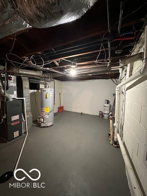 basement featuring gas water heater and heating unit