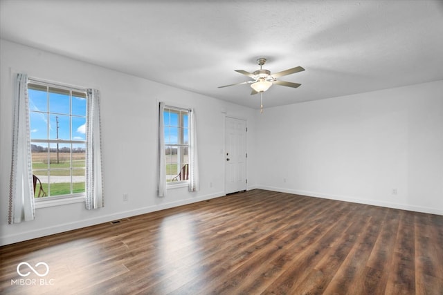 empty room featuring ceiling fan, dark hardwood / wood-style flooring, and a textured ceiling