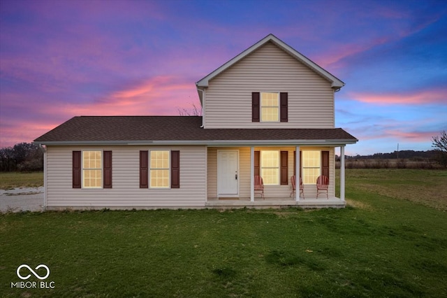 view of front of house with a lawn and a porch