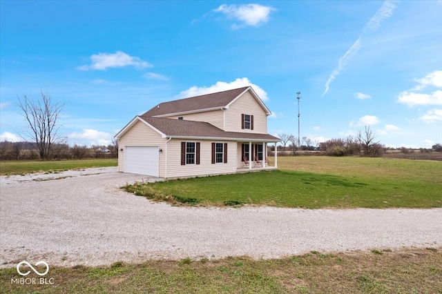 view of side of home with covered porch, a garage, and a lawn