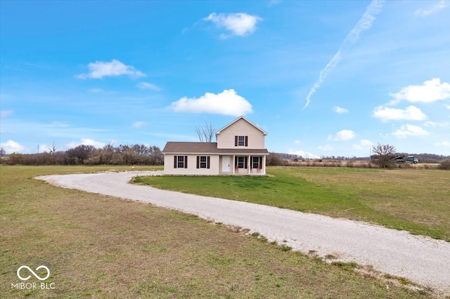 view of front of home featuring a front lawn, a rural view, and a porch