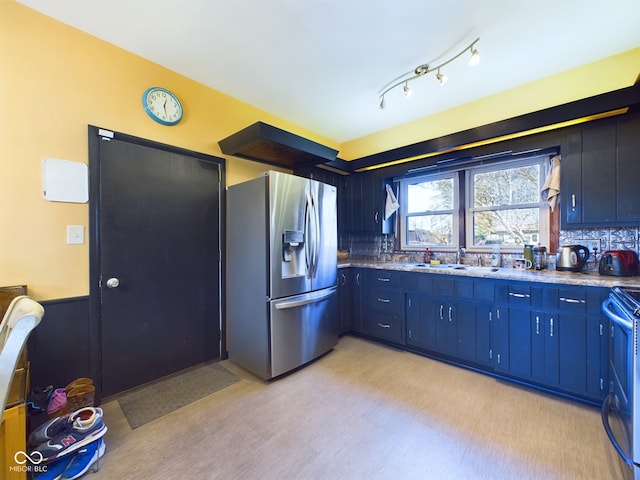 kitchen with tasteful backsplash, blue cabinetry, sink, and stainless steel appliances