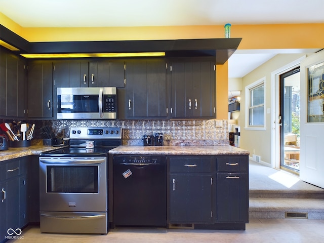 kitchen with stainless steel appliances, light carpet, and tasteful backsplash