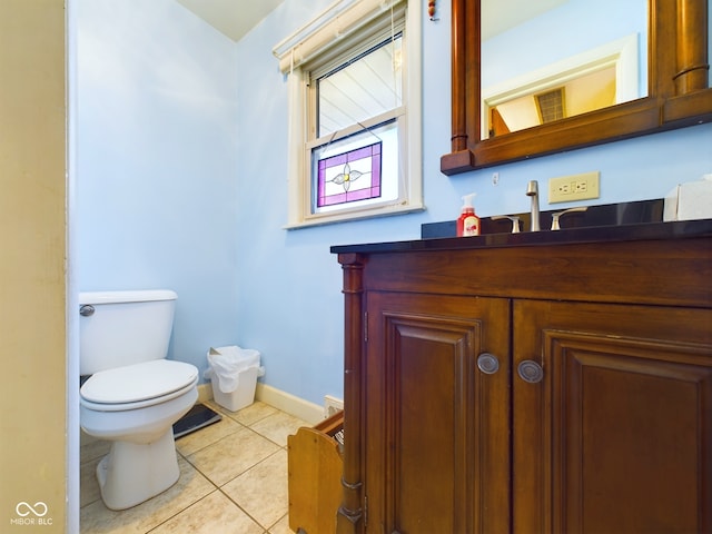 bathroom featuring tile patterned floors, vanity, and toilet