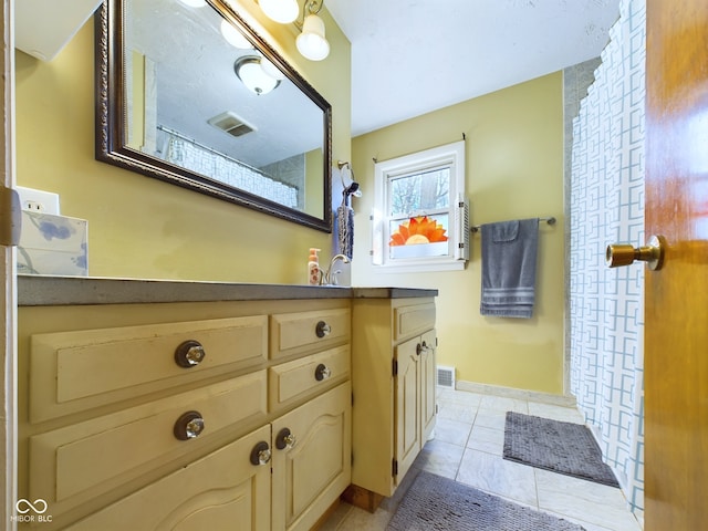 bathroom with tile patterned floors and vanity