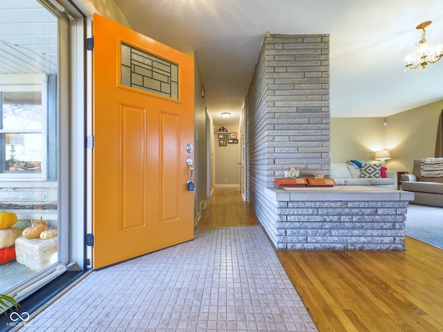 foyer with hardwood / wood-style floors and an inviting chandelier