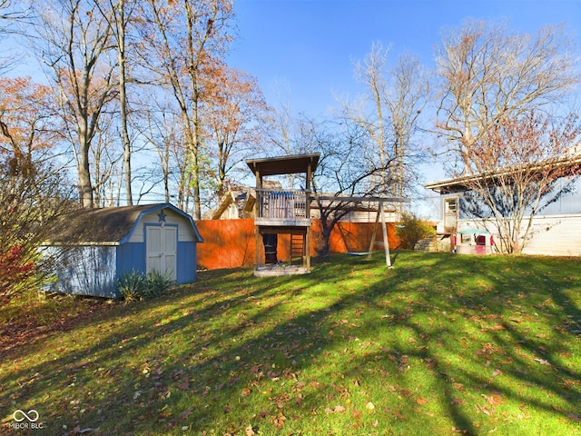 view of yard featuring a wooden deck and a shed