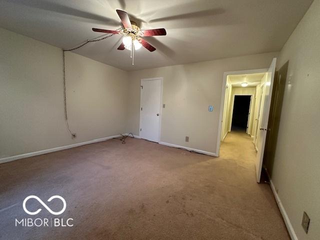 carpeted empty room with ceiling fan