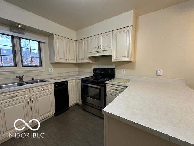 kitchen with white cabinetry, sink, kitchen peninsula, dark wood-type flooring, and stainless steel electric range