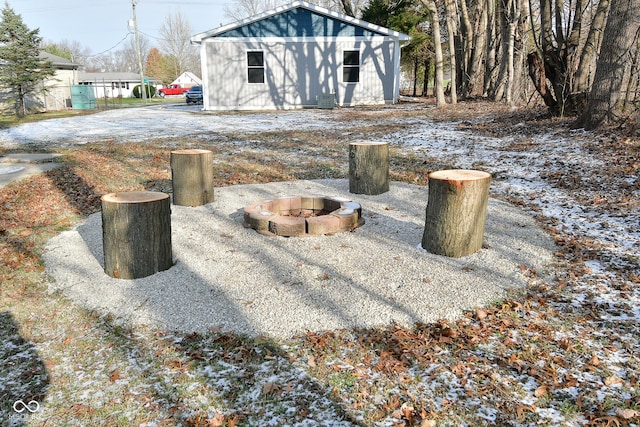 view of yard with a fire pit