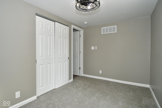 unfurnished bedroom with carpet floors and a closet