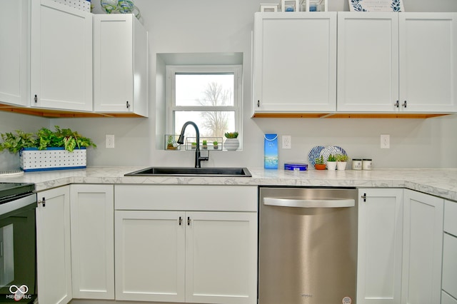 kitchen featuring appliances with stainless steel finishes, white cabinetry, and sink